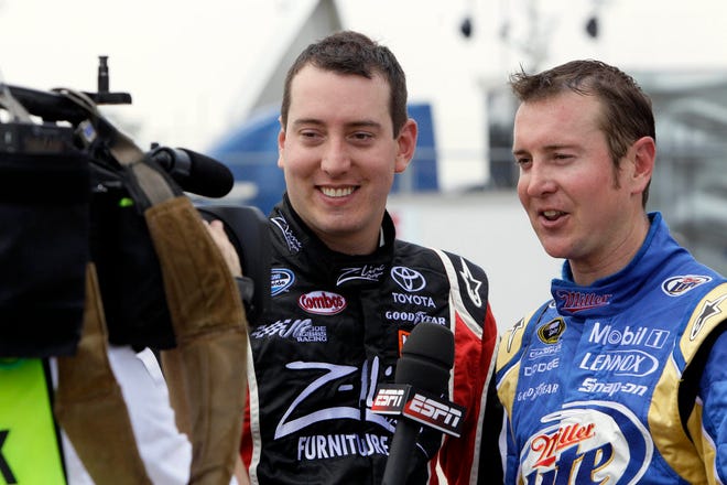 In this May 7, 2010, photo, Kyle Busch, left, and Kurt Busch are interviewed during practice for Saturday's NASCAR Sprint Cup Series auto race in Darlington, S.C. The Busch Brothers are finally running at the same level, setting up a potential sizzling showdown over the upcoming long summer stretch of racing. (AP Photo/Gerry Broome, File)