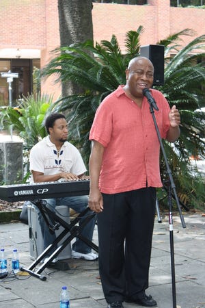 Onlookers watch as Roger Moss performs Johnny Mercer songs with keyboardist Eric Jones in Johnson Square as part of the Summer Concerts in the Squares 2009 series. (Cate Adams/Savannah Morning News file photo)