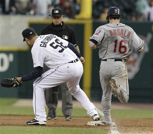 Detroit Tigers pitcher Armando Galarraga covers first base as Cleveland Indians Jason Donald hits the bag and first base umpire Jim Joyce looks on in the ninth inning of a baseball game in Detroit on Wednesday, June 2, 2010. Joyce called Donald safe and Galarraga lost his bid for a perfect game with two outs in the ninth inning on the disputed call at first base. Detroit won 3-0.