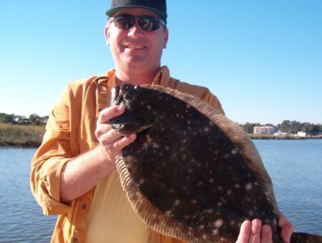 The happy customer above kept this 6-pound flounder and another one that was over 4 pounds, both caught within a foot of each other. Photo by Capt. Rick Reynolds