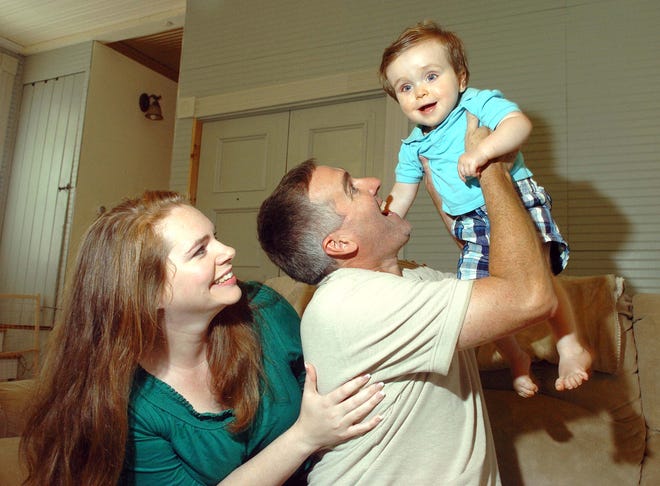 Margo LaPointe and her husband, Tom, play with their son, Avery, 11 months, at their Abington home.
