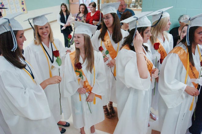 Students chat prior to their graduation ceremony on Saturday at Pembroke High School.