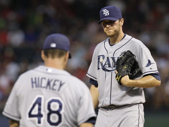 Tampa Bay Rays pitching coach Jim Hickey (48) pays starter Wade Davis a visit in the fourth inning of a baseball game against the Texas Rangers, Friday in Irving, Texas. Davis was pulled from the game in the same inning.