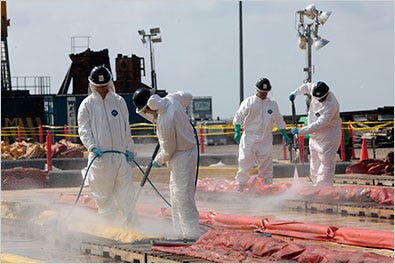 Oil cleanup workers used high-pressure hoses to decontaminate oil retention booms in Theodore, Ala., on Saturday.