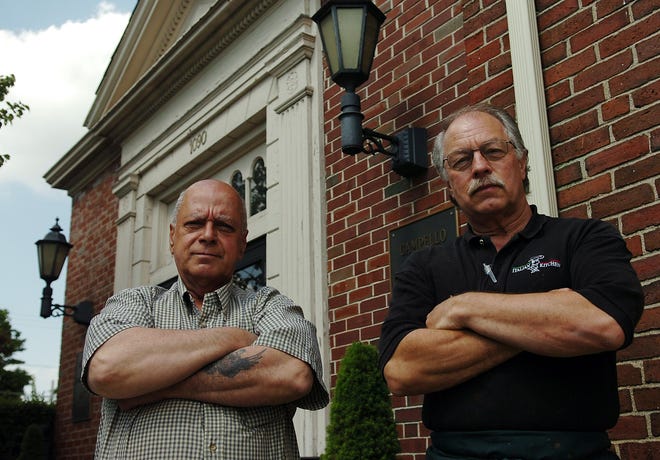 Campello business owners Ron Bethoney and Vinnie Zibelli stand in front of the Community Bank Building on Main Street where the YMCA had planned to open a facility for troubled youth.
