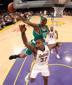 Boston Celtics forward Paul Pierce swats away a shot by Los Angeles Lakers forward Ron Artest during the second half of Game 2 of the NBA basketball finals Sunday, June 6, 2010, in Los Angeles. Boston won 103-94. (AP Photo/Christian Petersen, Pool)