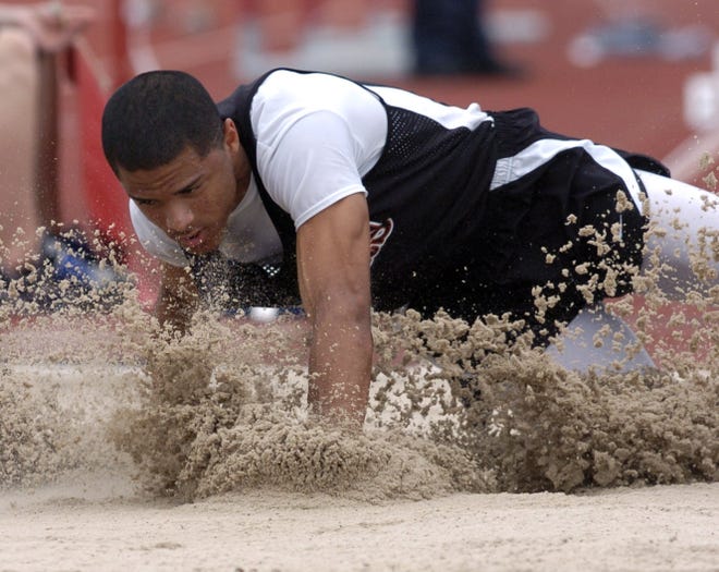 Massillon's Devin Smith lands in the pit during a jump in the long jump competition at the state track meet.