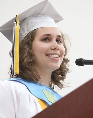Erica Krist delivers the honors essay for the class of 2010 during graduation ceremonies at Medway High School on Sunday afternoon.