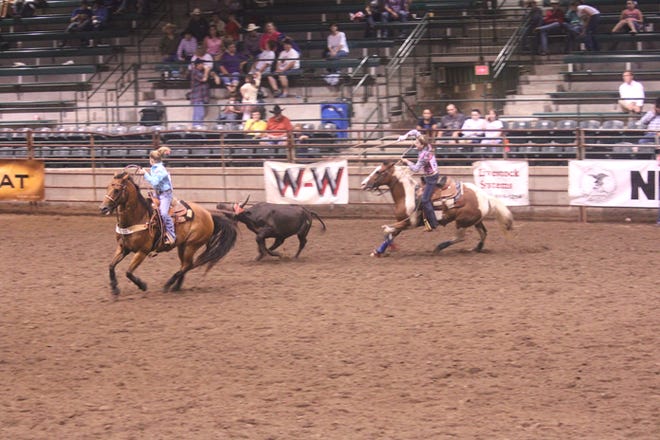 Header Kennedy Darbonne and heeler Torey Little of Hackberry High School compete in the team roping event Friday at the Louisiana Junior High Division Rodeo Finals at Lamar-Dixon Expo Center.