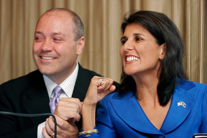 South Carolina Republican candidate for governor Rep. Nikki Haley, right, and her husband Michael Haley react to news of an early lead while watching the returns come in Tuesday night at the Capital City Club in Columbia.