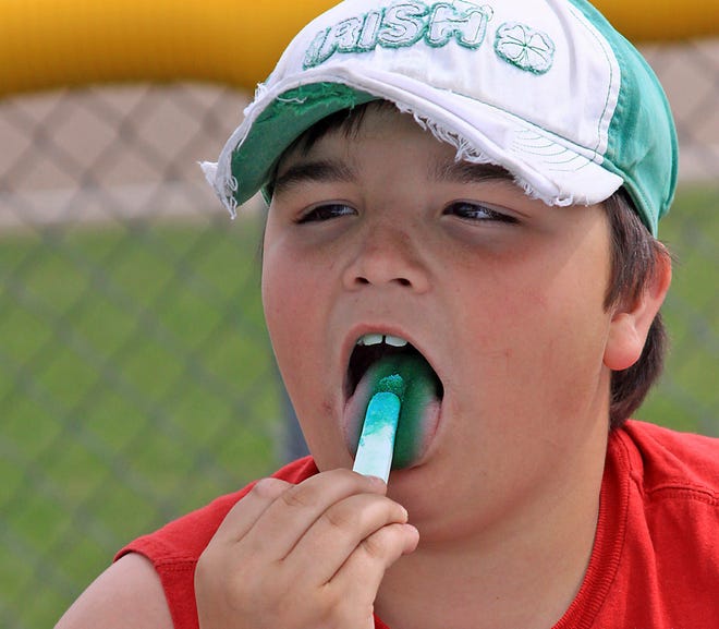 Aaron Krzycki, 11, of DeTour downed a Fun Dip while rooting for his cousin, Jacob Harrison, and the Rudyard High School Bulldogs as they played the Soo Black Sox from Canada on Tuesday. Krzycki and company had plenty to cheer about as they beat the Black Sox in both games of the double-header.