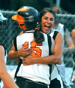Megan Andrade gives Emma Kenney a hug after scoring the tying run.