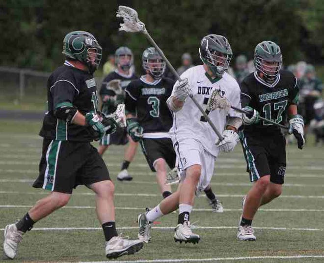 Duxbury's J.B. Marston bursts through the Marshfield defense in a Division 1 quarterfinal match at Duxbury High School on Wednesday, June 9, 2010. Duxbury won, 9-4, to advance to the semifinals of the Division 1 tournament on Saturday.