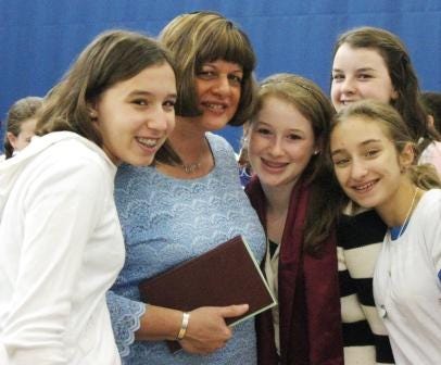Jane Taubenfeld Cohen, head of school at South Area Solomon Schechter School in Norwood, is surrounded by eighth graders, from left, Naomi Mayman of Canton, Lital Avnor of Sharon, Sarah Lopez of Sharon and Brittany Bell or Randolph.