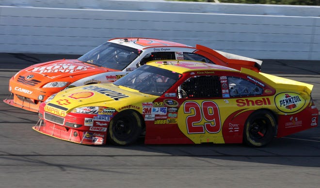 Joey Logano, rear, and Kevin Harvick drives out of Turn 2 late in the NASCAR Sprint Cup Series auto race Sunday, June 6, 2010, in Long Pond, Pa. A few laps later, Harvick nudged Logano into the wall while the drivers were battling for fourth with less than two laps to go. (AP Photo/Russ Hamilton Jr.)