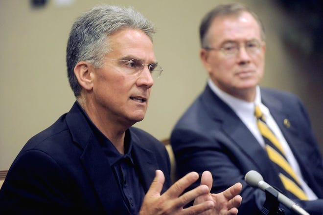 Athletic Director Mike Alden, left, and MU Chancellor Brady Deaton talk to reporters during a news conference yesterday at the Reynolds Alumni Center. Though Missouri appears to be left behind in the conference shuffle, Alden said fans and alumni have reasons to remain confident in the school’s future