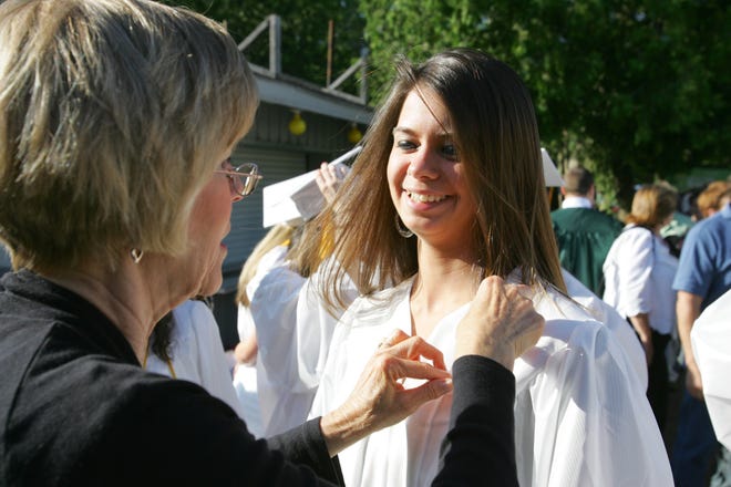 South Shore Vocational Technical High School allied health teacher Jeanne Boretti adjusts graduate Mary Loughlin's ribbon before graduation on June 11, 2010 at South Shore Music Circus in Cohasset.