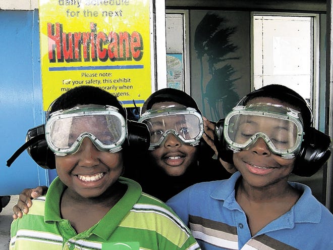 Students in the 2009 Summer Enrichment Program pose during a visit to the Museum of Science and Industry in Tampa, where they could apply math and science concepts they had learned.