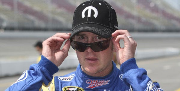 Kurt Busch adjusts his glasses after qualifying first for Sunday's NASCAR Heluva Good! Sour Cream Dips 400 Sprint Cup Series auto race at Michigan International Speedway in Brooklyn, Mich., on Friday.