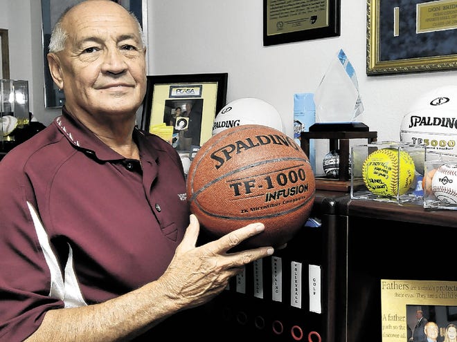 Polk County Director of Athletics Don Bridges holds one of the balls used in the Bartow state championship game. Friday, June 11, 2010.