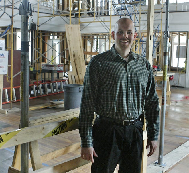 Travis Bond, new senior pastor of Medway Community Church stands inside the circa-1814 building during renovations.