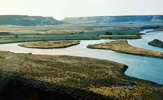 This file photo provided by the Idaho Historical Society shows Three Island Crossing on the Snake River near Glenns Ferry, Idaho. The Oregon Trail is one of many paths that cross from east to west, carved by pioneers migrating on foot, in wagons, or on horseback toward the promise of land, gold, or just a better life. Most of the emigration occurred between 1843 and 1869, tapering off quickly when the transcontinental railroad was completed.