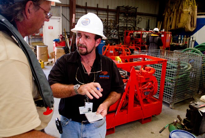 Frank Leckey, Vice President of Operations and Technical Manger for Resolve Marine Group, discusses a pump setup at Resolve Marine Group's facilities in Theodore, Ala., Saturday, June 12, 2010. Resolve has been involved with the Deepwater Horizon oil spill since the beginning with fire fighting efforts and now in the deployment of booms and offshore oil skimming operations.