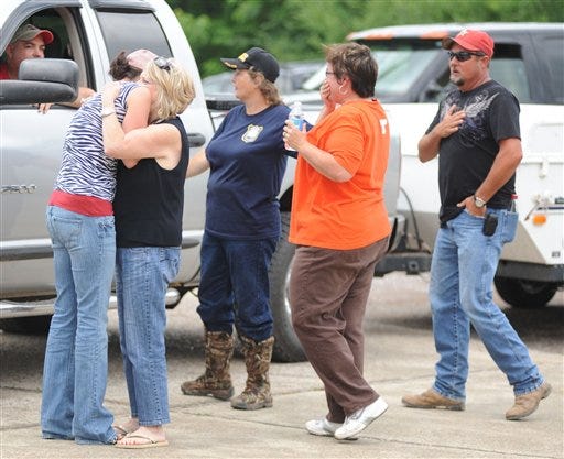 Family and friends of campers react June 11 in Langley, Ark., near the Albert Pike Recreation Area on the Little Missouri River after a flash flood in Langley, Ark. where numbers of people who were camping died. (AP Photo/The Sentinel-Record, Mara Kuhn)
