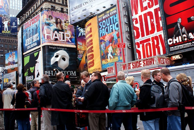 Patrons line up for discount theater tickets in New York City's Times Square.