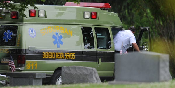 Suburban EMS workers leave the scene Monday morning at Prospect Cemetery in East Stroudsburg, where a former Bartonsville man was found dead.