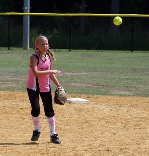 Shelby Barfield of the Hendrix Park 10U softball team fires the ball to first base Saturday.