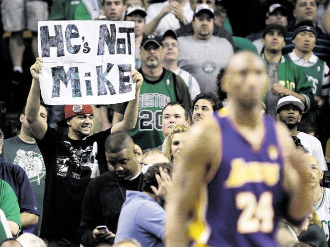 Los Angeles Lakers guard Kobe Bryant (24) walks up court as a fan holds a sign comparing Bryant unfavorably with Michael Jordan, during the fourth quarter in Game 5 of the NBA basketball finals against the Boston Celtics on Sunday, June 13, 2010, in Boston. The Celtics won 92-86 and lead the series 3-2.