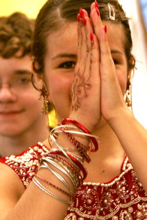 Amanda Romanelli and Zachary Ruby, both 13, and seventh-graders, dressed in traditional Indian clothing dance the Jaiho, a modern popular dance in India during the Culture Fair at Memorial Middle School in Bellingham Thursday.