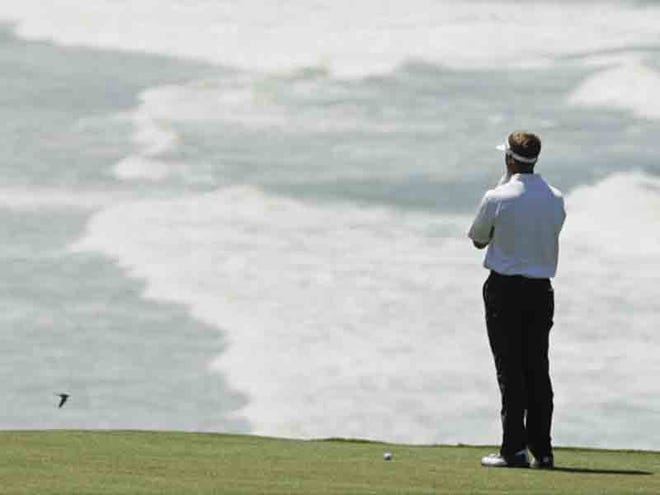 STUART APPLEBY looks over a shot on the ninth hole during a practice round of the U.S. Open Golf Tournament. The tournament will be held at Pebble Beach this year.