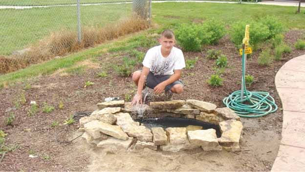 Alex Warthen worked on the butterfly garden at Kewanee High School this summer for an Eagle Scout program.