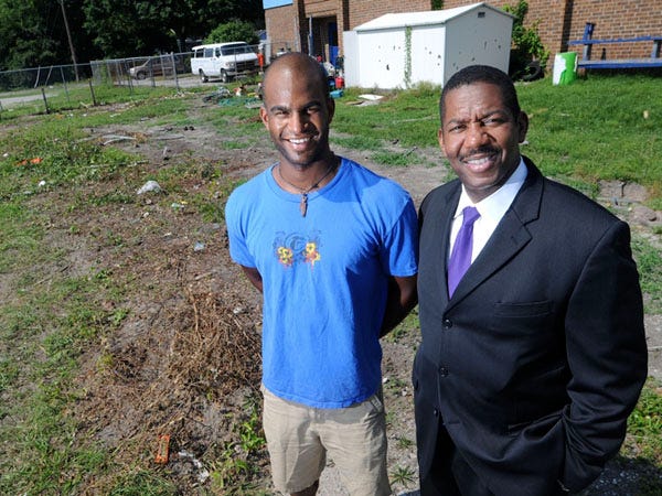 David Branch (left), athletic director at the Community Boys and Girls Club of Wilmington and Cedric Dickerson, the board chairman at the club, stand at the site behind the club Thursday where a new playground will be installed in Wilmington.