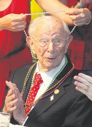 Beads are places around the neck of Sidney Gilbert, a Kiwanis Club of Lakeland member with 60 years of service, during a celebration of his upcoming 106th birthday, which will be June 30. Gilbert, of Lakeland, was recently recognized by the International Kiwanis organization as its oldest living member.