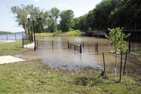 A walkway at the south end of Landing Park remains closed Monday because of flooding in the area where Three-Mile Creek empties into the Missouri River.