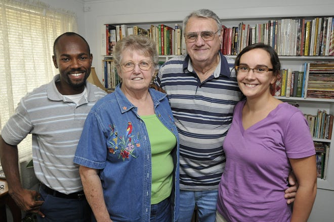 Ricot Leon, left, is one of eight adopted Haitian children of Marlene and Bill Burch who are seen with Ricot's wife Mandy, right. Monday, June 19, 2010.