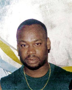 In this undated file photo, alleged drug gang leader Christopher "Dudus" Coke is shown. Coke, who eluded a bloody police offensive in his slum stronghold last month, surrendered to authorities outside Jamaica's capital Tuesday, local news media reported.