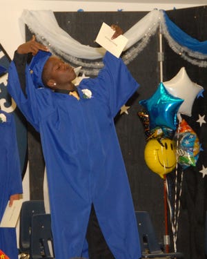 Butteville Graduate Nearthur Walker has fun taking a moment to pose as he exits the stage after receiving his diploma on June 18, 2010.