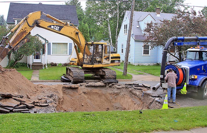 City of Sault Ste. Marie crews work to repair a sinkhole that had formed in the 600 block of Spruce on Tuesday. According to Jim Atkins, head of the City’s Street Department, an untapped sewer lead needed to be replaced at this location as it was washing material out from under the paved road surface. The underground work has been completed, but the re-paving portion of this project has not yet been scheduled.