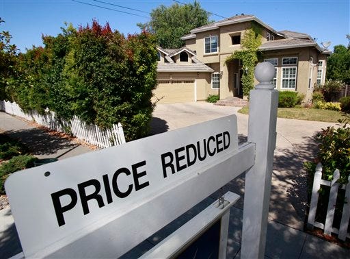 A home for sale is posted at a reduced price in Palo Alto, Calif., Thursday, June 24, 2010. Mortgage rates fell this week to the lowest level on record, giving consumers added incentive to lock in low payments for home purchases and refinanced loans.
