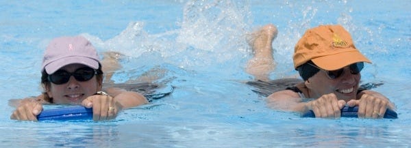 Winter Haven , Florida, September 13, 2006, at the Rowdy Gaines Pool, Samantha Krawciw (left), of Winter Haven, is seen swimming Wednesday afternoon for exercise and a way to beat the heat. Samantha, who was on the United States Air Force Swim Team in the late 1980's, has been swimming at the pool with her mother, Sandy Morgan (right) ( also of Winter Haven), three times a week for the past three weeks.