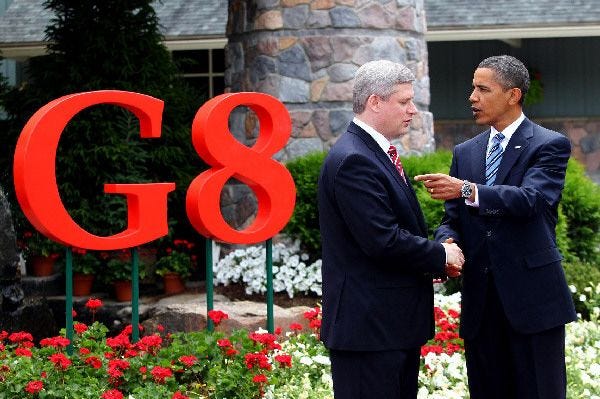 President Barack Obama greets Canadian Prime Minister Stephen Harper, the host of this year's Group of Eight summit, in Huntsville, Ontario, yesterday. Obama favors more spending worldwide to avoid a prolonged recession, but many European leaders, worried about big deficits, favor budget cuts and raising taxes.