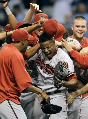 Arizona Diamondbacks pitcher Edwin Jackson, center, celebrates after throwing a no-hitter against the Tampa Bay Rays on Friday in St. Petersburg, Fla.