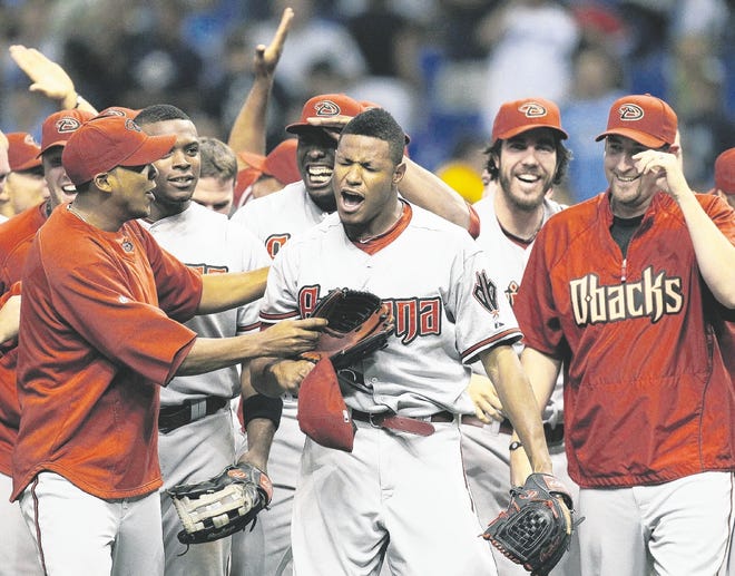 ARIZONA PITCHER EDWIN JACKSON, CENTER, celebrates with teammates after throwing a no-hitter against the Tampa Bay Rays on Friday night at Tropicana Field. Jackson walked eight batters and threw 149 pitches as he became the second Diamondbacks pitcher to throw a no-hitter, following Randy Johnson's perfect game in 2004.