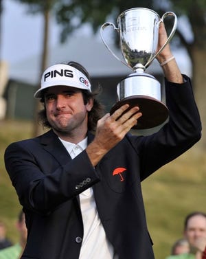 Bubba Watson holds up the championship trophy at the Travelers Championship golf tournament on Sunday, June 27, 2010, in Cromwell, Conn. Watson won for the first time on the PGA Tour, coming from six shots down to win the Travelers Championship in a three-way playoff. (AP Photo/Jessica Hill)
