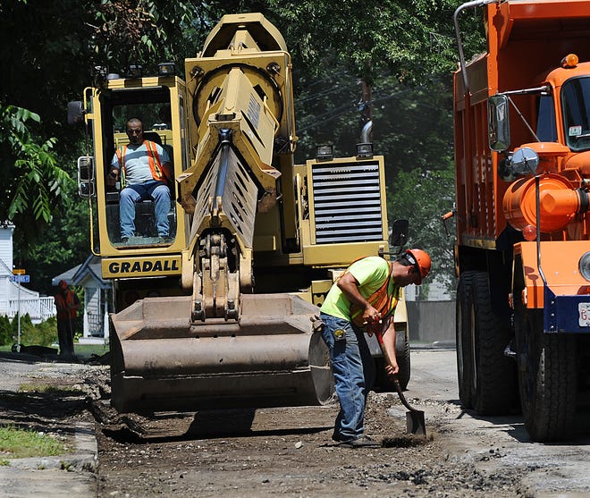 A grading machine works over a new water main on Concord Street iin Framingham.