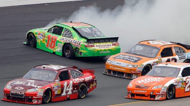 Driver Kyle Busch (18) spins as Tony Stewart (14), A.J. Allmendinger (43) and Joey Logano (20) pass safely during the NASCAR Lenox Industrial Tools 301 Sprint Cup Series auto race at New Hampshire Motor Speedway in Loudon, N.H., Sunday.